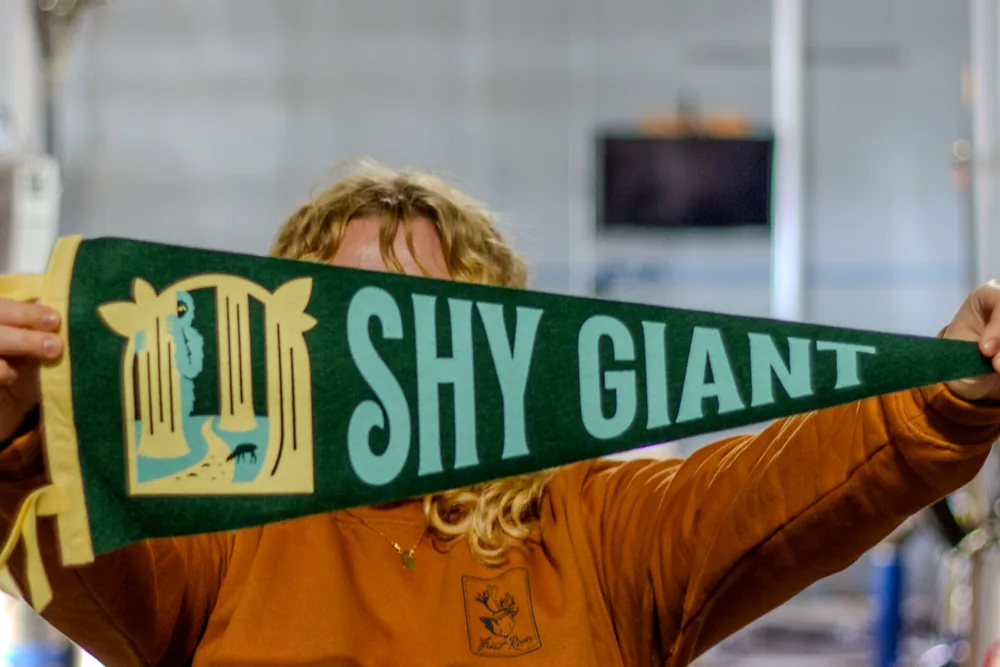 A Shy Giant pennant held up in the taproom